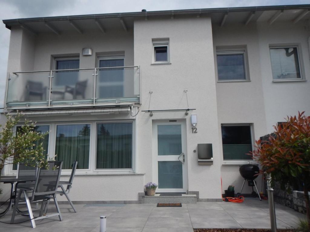 a white house with a balcony on the side of it at Viktoria in Koblenz