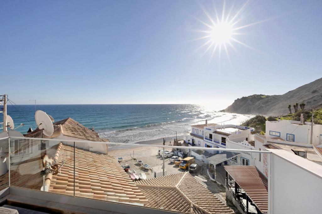 a view of the beach from the balcony of a house at Casinha in Burgau