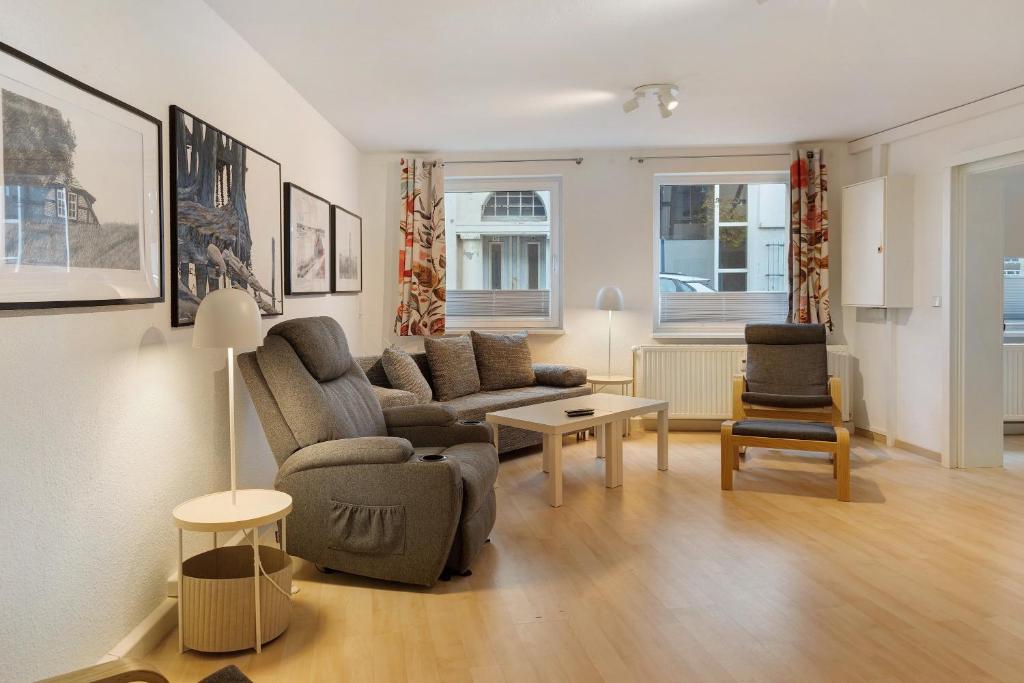 a living room with a couch and a chair at Ferienwohnung im Denkmal in Havelberg