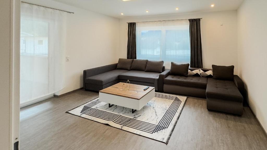 a living room with a couch and a coffee table at Ferienhaus Koca in Imsterberg