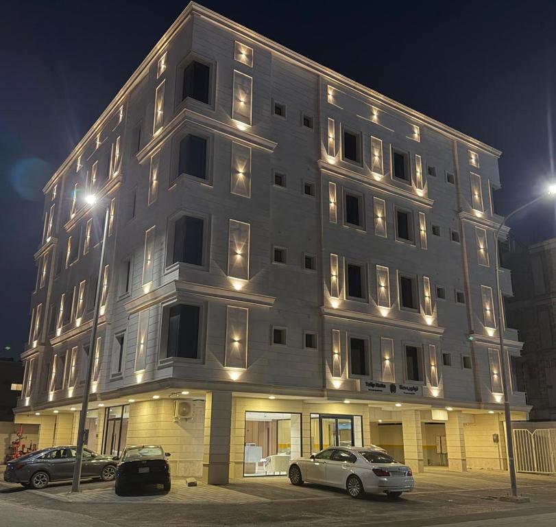a large building with cars parked in front of it at توليب حتا 2 Tulip Hatta in Al Khobar