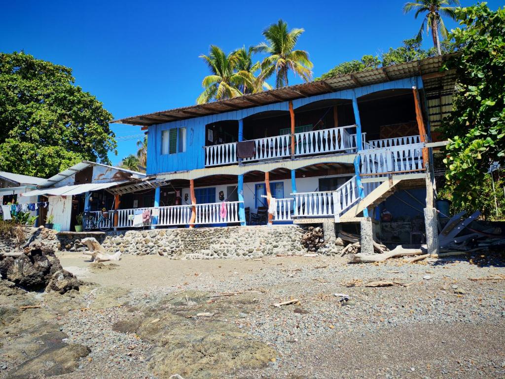 a house on the beach with a monkey in front of it at Hotel Lucy in Montezuma