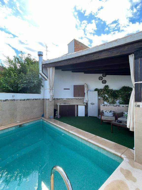 a swimming pool in front of a house at La morena in Guaro