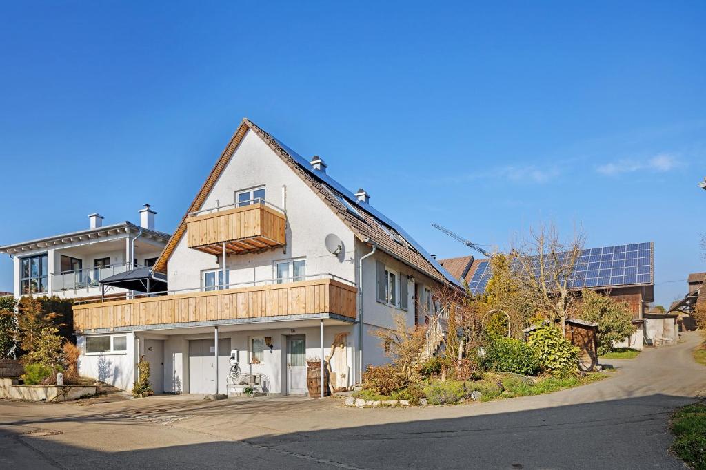 a large white house with a porch on a street at Caroline Magg in Lindau