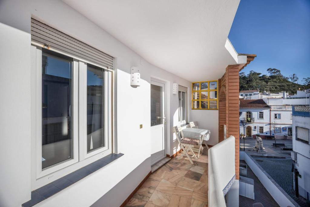 a balcony with a view of a house at Apartamento Amarelo T1 in Odeceixe