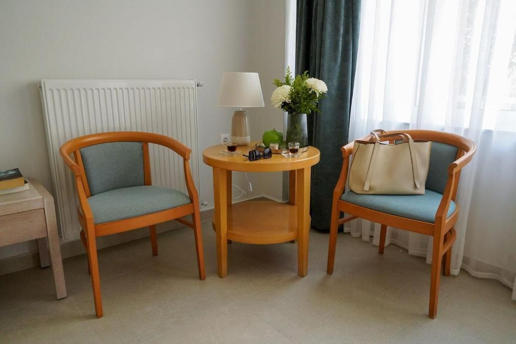 a room with two chairs and a table with a lamp at Casa Marjeta in Chania