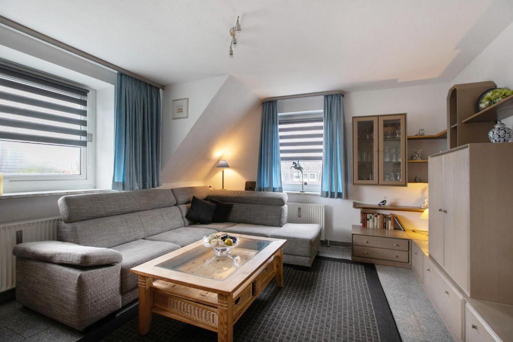 a living room with a couch and a coffee table at Sylt Ferienwohnung 4 Westerland in Westerland