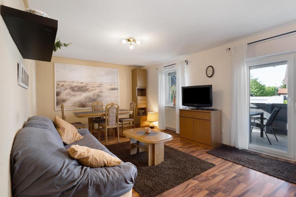 a living room with a couch and a table at Haus Kornfeld in Kehl am Rhein