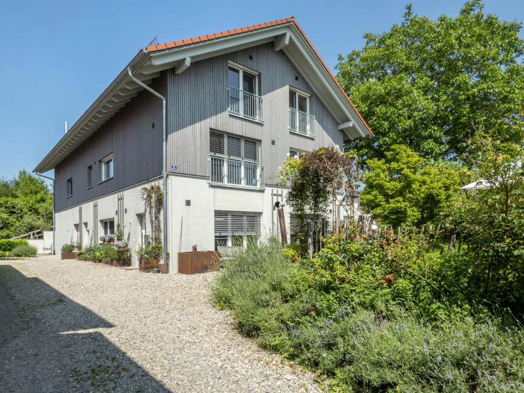 a large gray and white house with a gravel driveway at Ferienhof Mrowka in Reutin