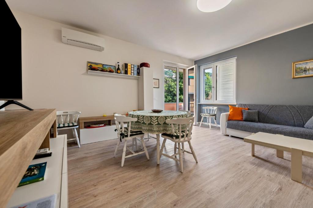 a kitchen and living room with a table and chairs at My town home apartment in Torri del Benaco
