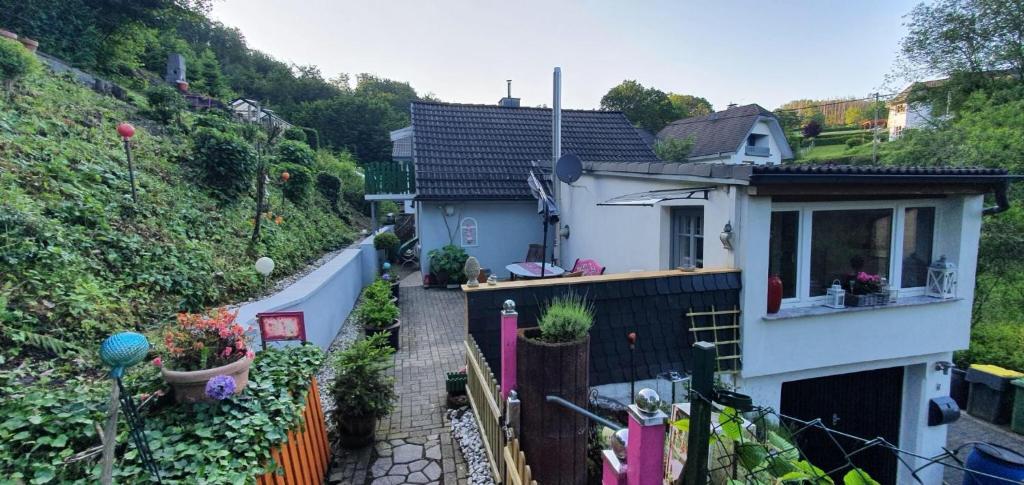 a small white house with a fence at Ferienhaus am Wald in Reichshof 