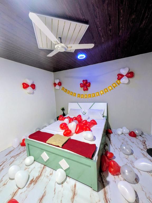 a bedroom with a bed with red and white decorations at Gawkari Hillside Agroturism in Satara