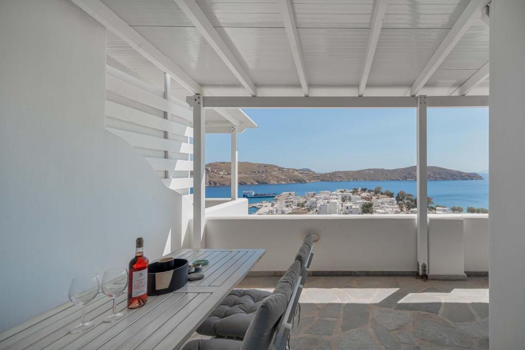 a balcony with a table and a view of the ocean at Bella Vista Vacation House in Serifos Chora