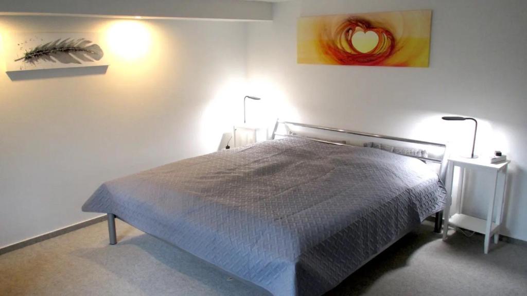 a bedroom with a bed in a white room at Fewo Deister Bikertraum in Wennigser Mark
