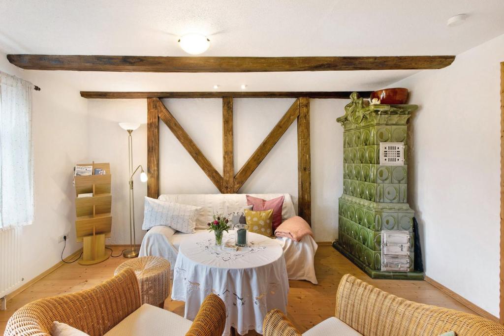 a living room with a table and a fireplace at Ferienwohnung Gute Stube in Veckenstedt