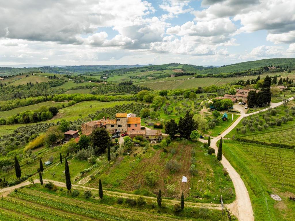 a small village in the middle of a green field at Vallone di Cecione in Greve in Chianti