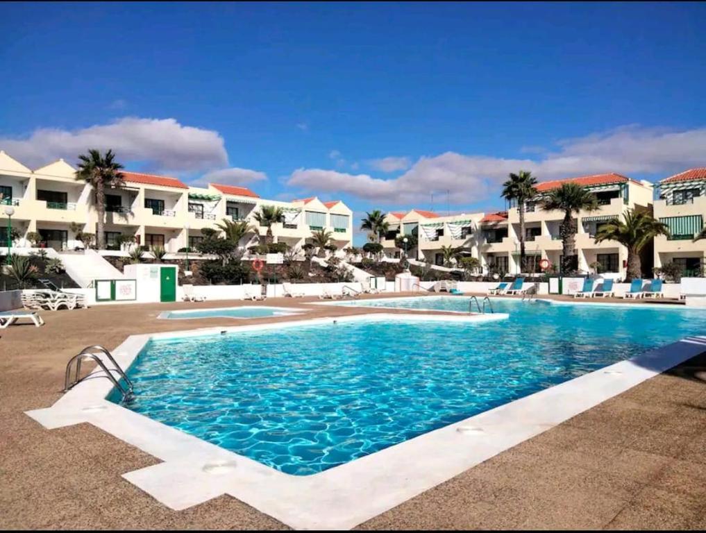 a swimming pool in the middle of a resort at Torres in Antigua