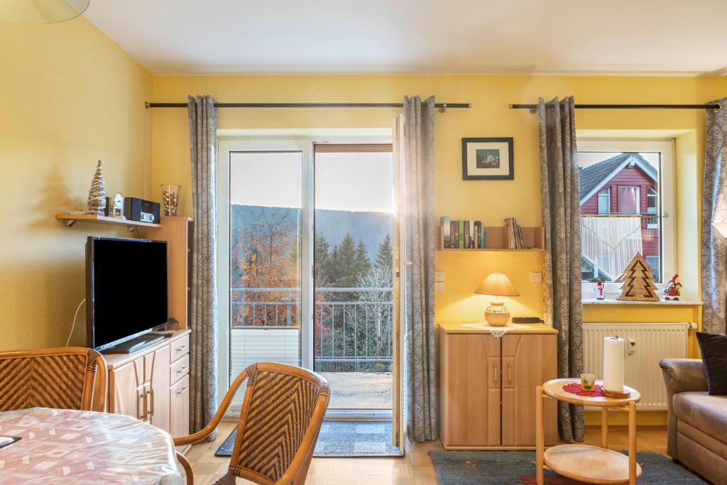 a living room with a sliding glass door at Ferienwohnung Tannenblick 1-3 in Oberhof