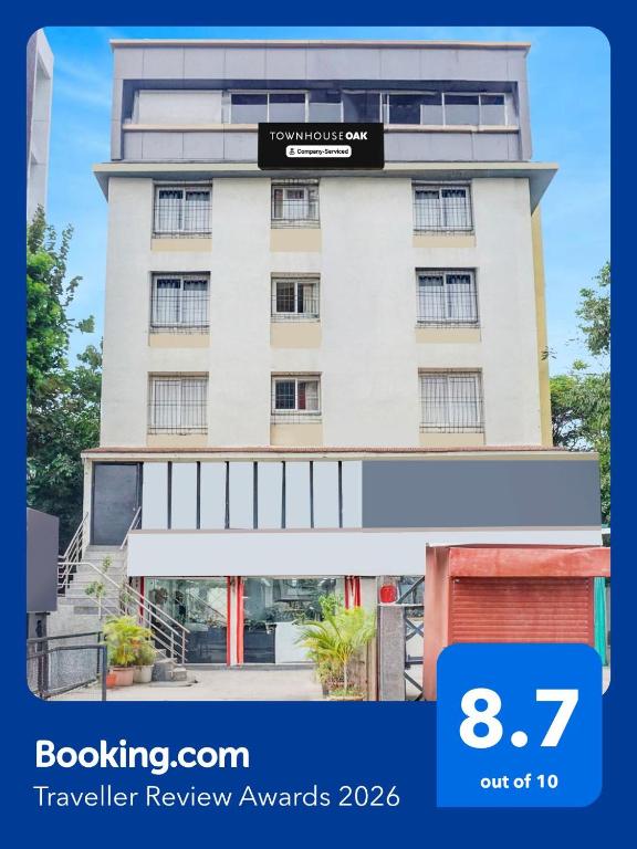 a building with a sign on top of it at Townhouse Oak Gravity Inn in Pune