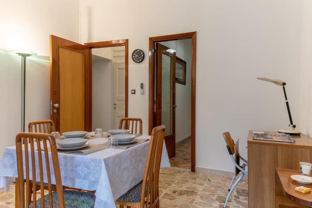a dining room table with plates and bowls on it at Vito 80 in Chiaramonte Gulfi