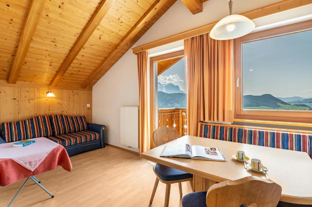 a living room with a couch and a table at Haus Alpenblick Apt Brunelle in Laion