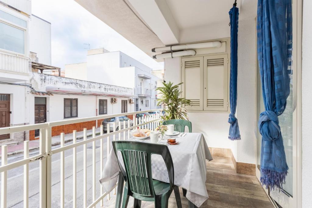 a white balcony with a table and chairs on it at Casavacanzefranca - 12 in Terrasini