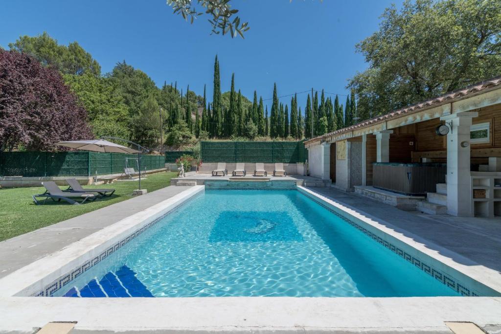 a swimming pool in the backyard of a house at Domaine du Courroussouve in Oppède