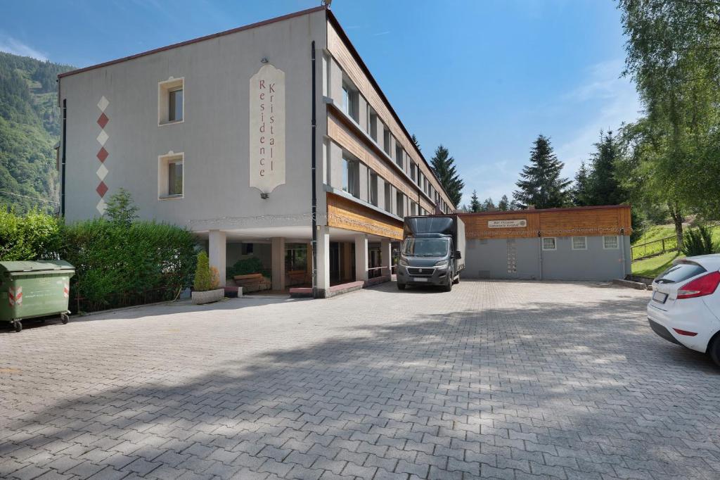 a truck parked in a parking lot next to a building at Marilleva 900 Kristall in Mezzana