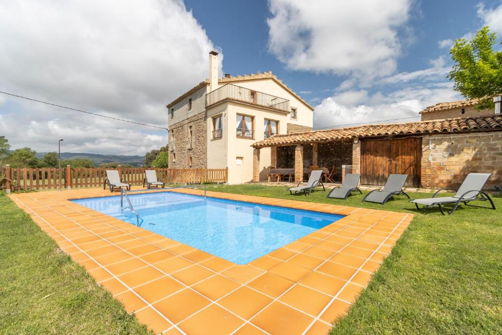 an external view of a house with a swimming pool at Casa ponet in Solsona