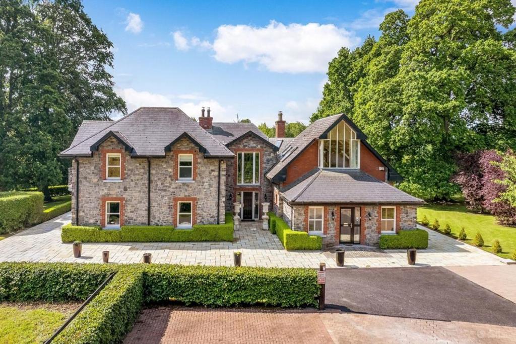 a large brick house with a courtyard at Ballagh House in Navan