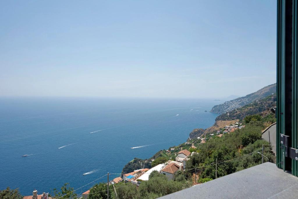 a view of the ocean from a building at Dimora elegante in Costa d'Amalfi in Conca dei Marini
