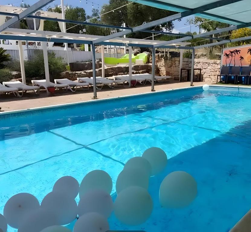 a large swimming pool with blue water at Oasi Torre Di Mastro, Conversano in Conversano