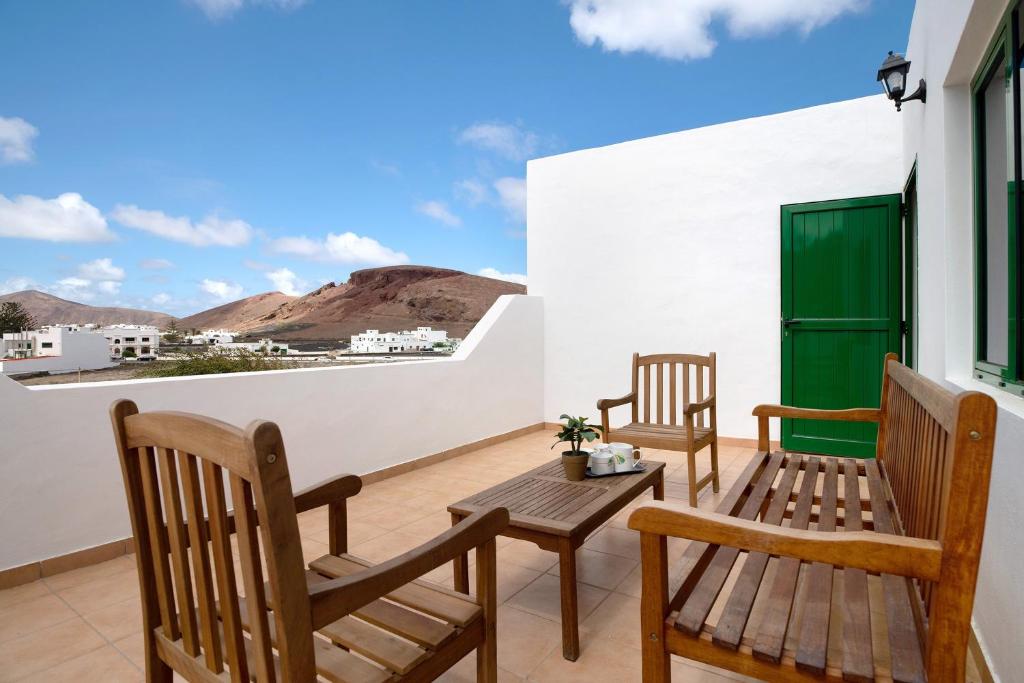 two chairs and a table on a balcony at San roque in Tinajo