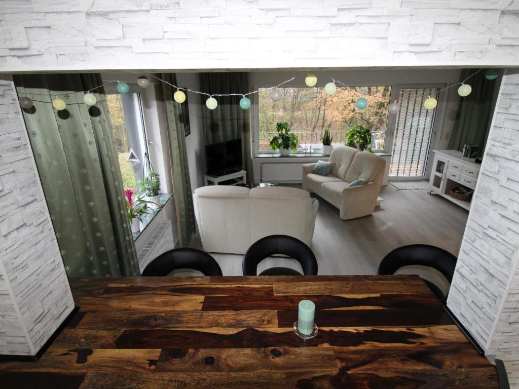 a living room with a table and a couch at Ferienwohnung Möhneblick in Möhnesee
