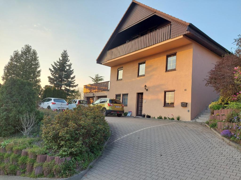 a house with a car parked next to a driveway at Haus schöne Aussicht bei Chemnitz in Chemnitz