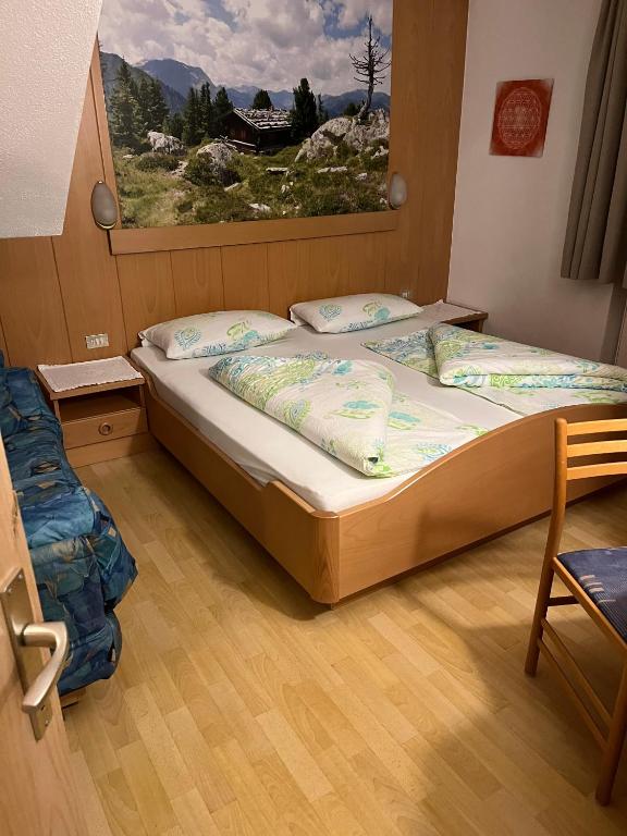 a bedroom with a bed with a large window at App Sonne Nr 17 in Lutago