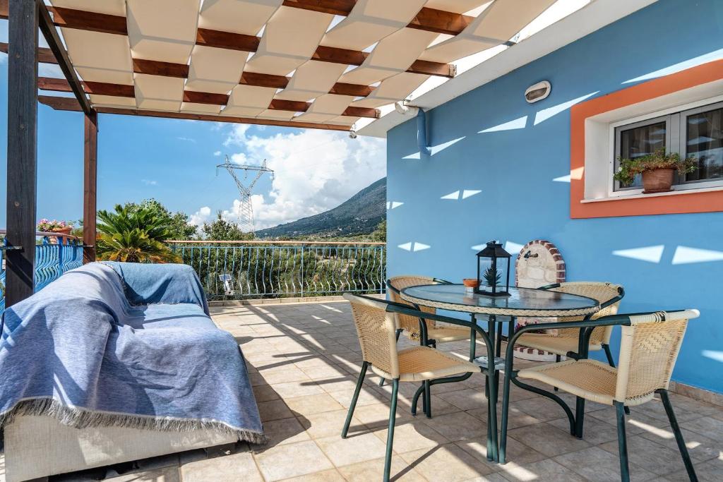 a bedroom with a table and chairs on a patio at Efrosyni apartment in Kefallonia