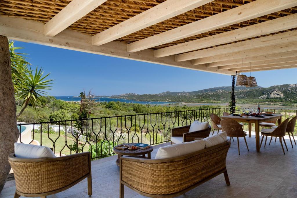a patio with a table and chairs and a view at Villa Amata in Arzachena