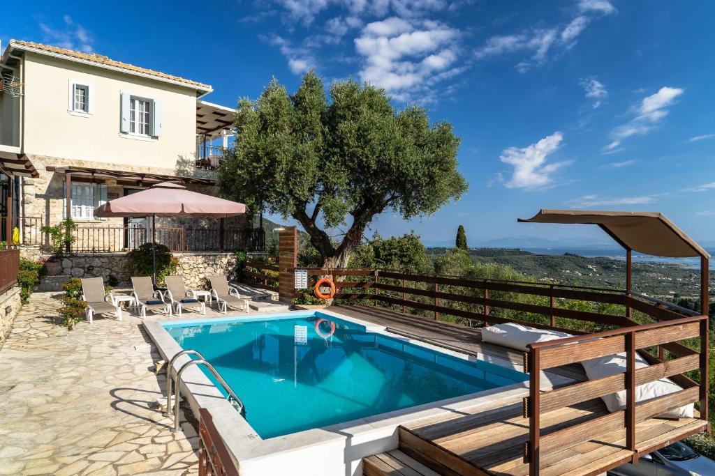 a villa with a swimming pool and a house at Afroksilia Villa Triantafilo in Lefkada