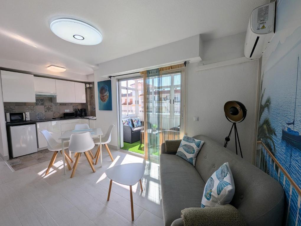 a living room with a couch and a kitchen at R-23 Modern apartment in La Mata in La Mata