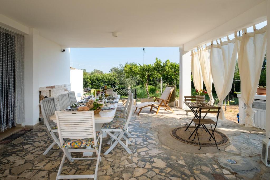 a patio with a table and chairs on a patio at Villa Grazia in Gallipoli