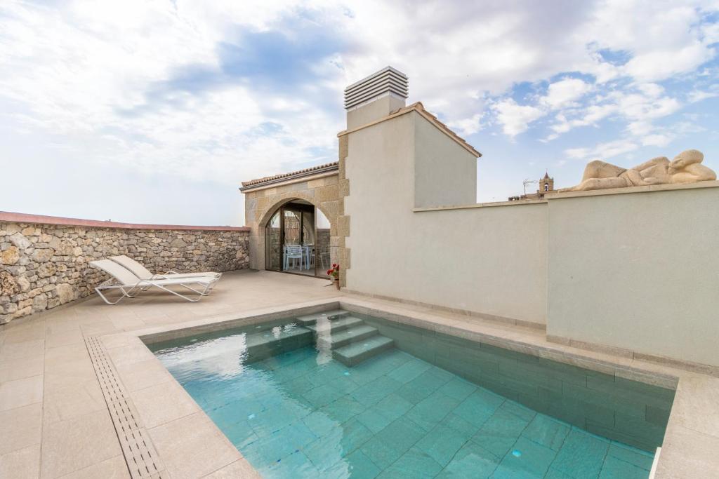 a swimming pool in the backyard of a house at El Paller de Cal Maso in Guisona