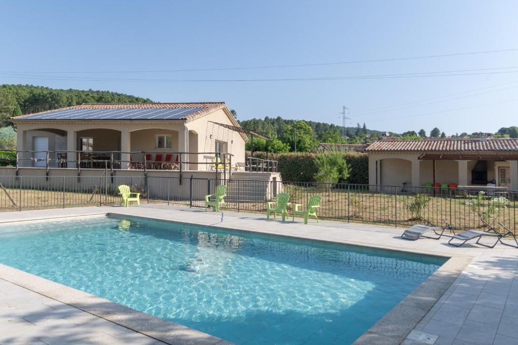 a swimming pool in front of a house at Villa Luminières 2 in Sallelles