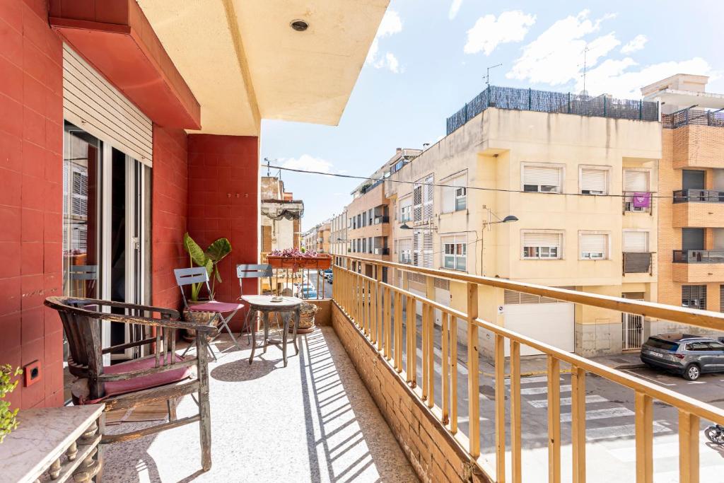 a balcony with a table and chairs on a building at San Antonio in Sedaví