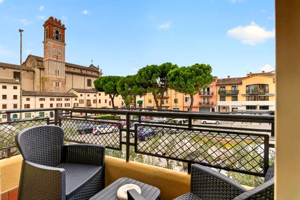 a balcony with chairs and a view of a city at Casa Sandrina in Caprino Veronese