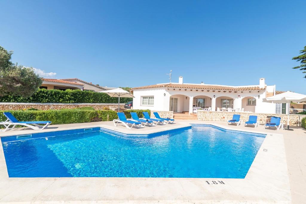 a villa with a swimming pool and a house at Villa Arena Blanca in Sant Lluis
