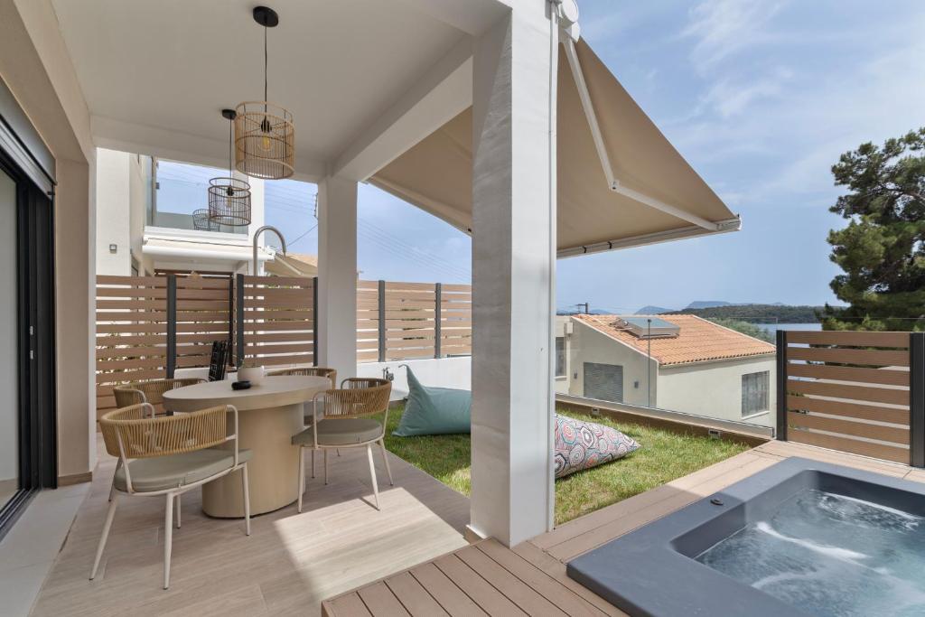 a home with a jacuzzi tub on a deck at Mella Roa - Ivory in Nydri