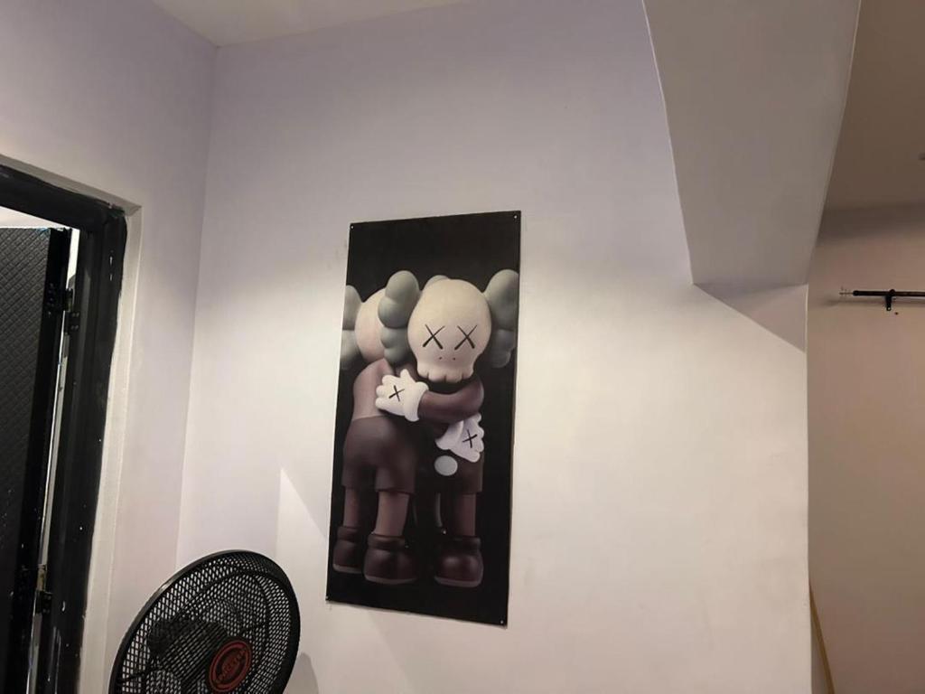 a picture hanging on a wall in a room at Lux Apartment in Agege