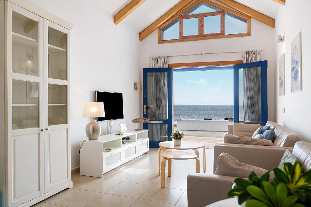 a living room with a view of the ocean at La Mariana in Punta Mujeres