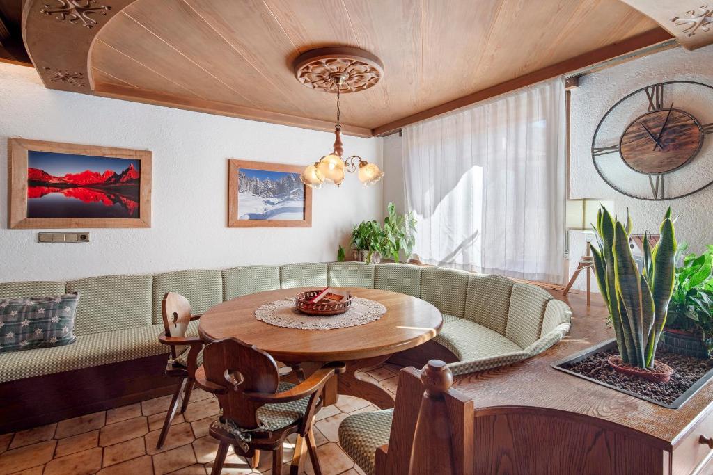a living room with a table and a couch at Dimora Il Feudo - Predazzo in Predazzo